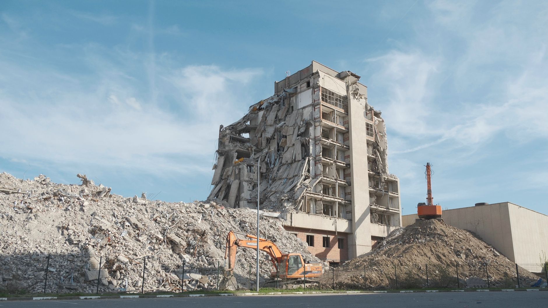 Urban demolition scene with a digger at a construction site